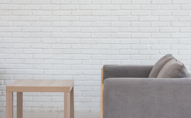 sofa and wooden table on white brick background Vintage style in a holiday coffee shop.