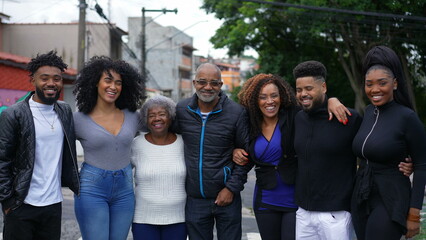 An African Brazilian family posing for photo outside
