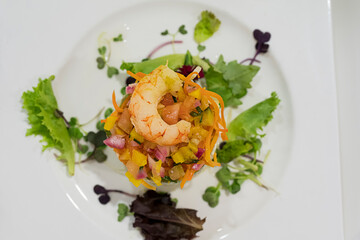 tasty vegetable and shrimp salad on a white plate