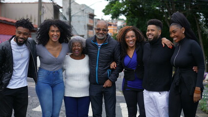 An African Brazilian family posing for photo outside