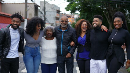 An African Brazilian family posing for photo outside