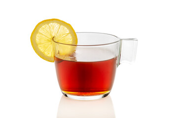 Clear glass cup of tea with lemon slice, isolated on white