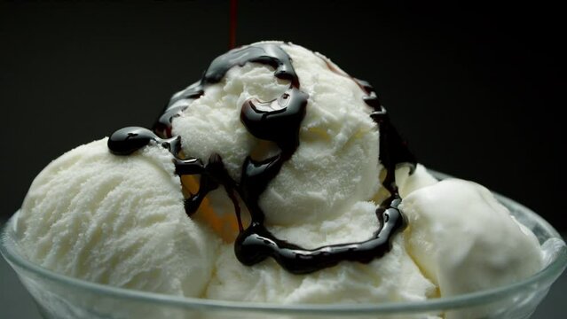 Chocolate pouring on vanilla ice cream