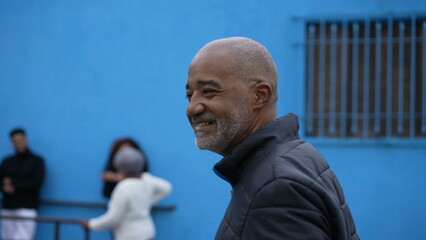 A senior African American person walking outside in street portrait face