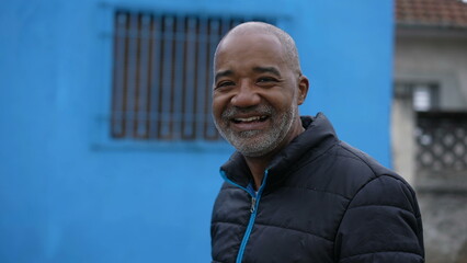A senior African American person walking outside in street portrait face