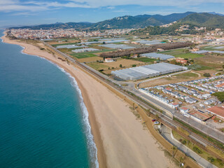 Aerial images of the beach of Malgrat de Mar in the Maresme Costa Brava pine forest without people drone