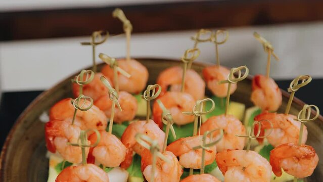 There are beautiful delicious shrimp canapes on the plate. The food was filmed in close-up