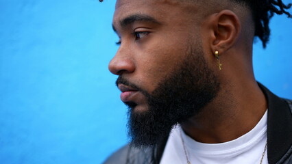 A pensive black man face closeup thinking