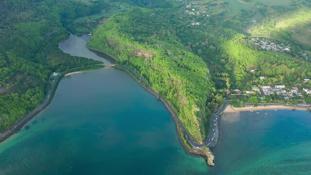 Maconde beach bathing in beautiful sunlight with amazing surrounding landscape. Aerial shot of beautiful Mauritius scenery.