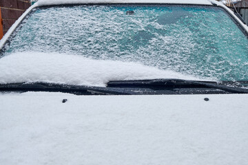 car glass covered with fallen fresh snow