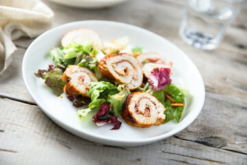 Fototapeta na wymiar Homemade chicken roulade with salad
