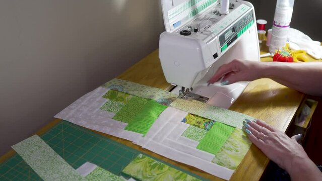 Sewing quilt block together on a sewing machine - slow motion log-cabin pattern