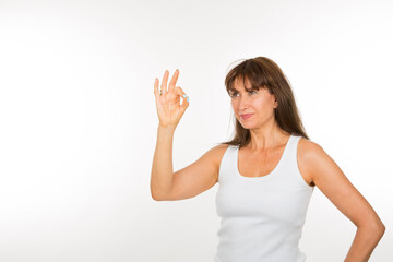 Fototapeta na wymiar senior woman with okey gesture on white background