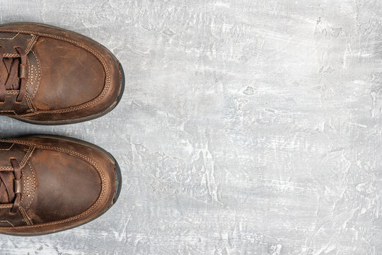 Mens Brown Leather Walking Shoes On Textured Background, Top View With Copy Space