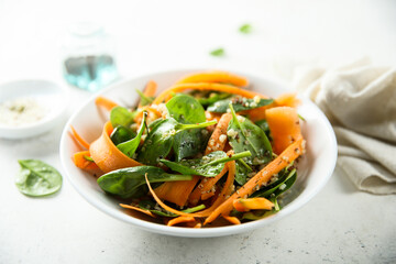 Healthy homemade spinach salad with carrot and sprouts