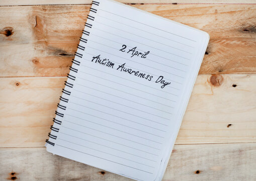 2April Autism Awareness Day written on notebook