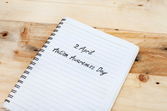 2April Autism Awareness Day written on notebook