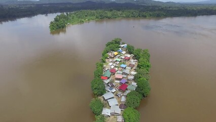 Aerial drone footage flying over unique remote island village in the Amazon South America.