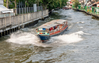 Obraz premium Water taxi on a canal in downtown Bangkok Thailand