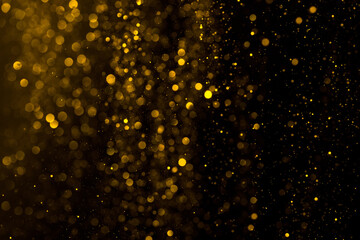 Abstract shiny golden glitter particles and bokeh background