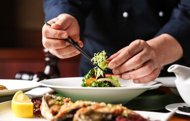 Hotel chef. The chef is cooking high-quality dishes.