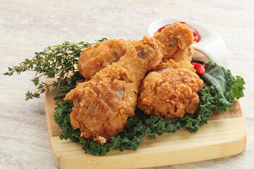 Fried chicken drumsticks with tomato sauce