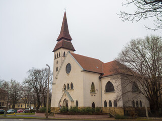 Fototapeta na wymiar Reformed Parish in Debrecen on Mester Street. Beautiful church in cloudy winter day in Hungury.
