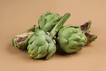 Obraz premium Concept of healthy food with artichoke on light brown background