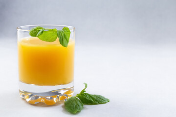 Orange juice in glasses and fresh oranges on a gray background. Concept. Photo