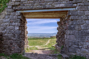 Entrance opening in an ancient thick brick wall of Radicofani fortress. Tuscany, Italy