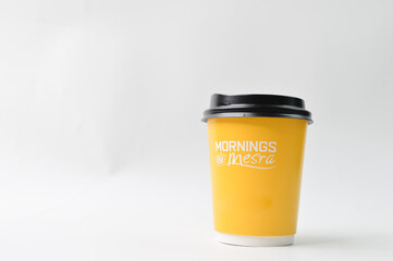 Yellow coffee cup isolated on a white background