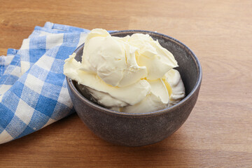 Italian soft mascarpone cheese in the bowl