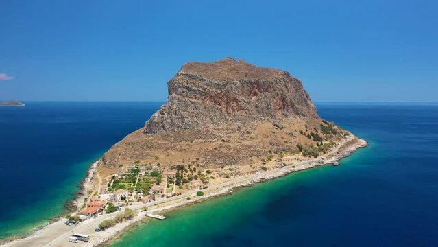 Aerial drone video of beautiful castle and medieval old city of Monemvasia in the heart of Lakonia with beautiful clouds and deep blue sky, Peloponnese, Greece