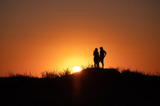 silhouette of a couple with sunset background 