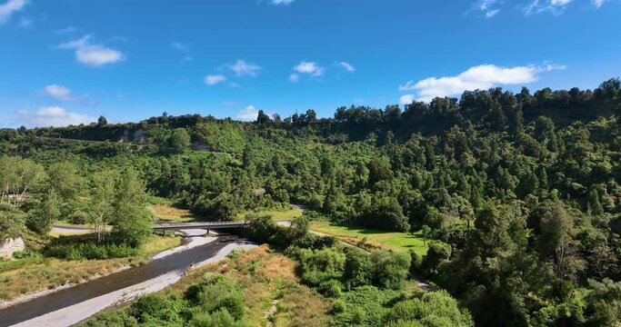 Aerial over river bridge, Manawatu Scenic Highway, and dense native forest