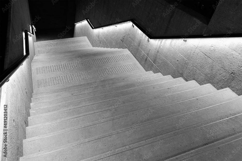 Aufkleber Interior view of empty stairway with illuminated bannister in modern architecture