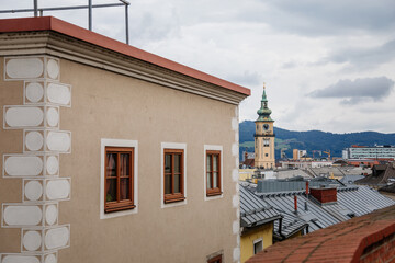 Linz, Austria, 29 August 2021: Narrow picturesque street, Facade of colorful buildings in historic center of medieval city, renaissance and baroque houses at summer sunny day, cafe with wooden windows