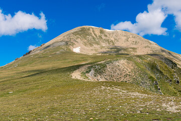 Hiking the high peak in the mountains (Peak of Bastiments, Pyrenees Mountains, Spain, Ulldeter)