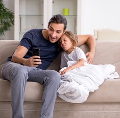 Father taking care of his ill daughter