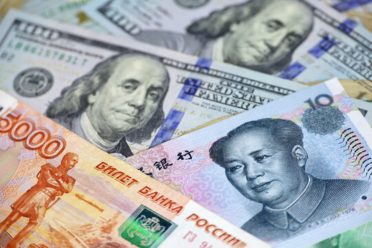 Chinese yuan, russian rubles and US dollars banknotes. Concept of trade war between the China and USA, sanctions against Russia