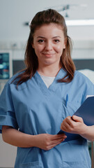 Portrait of medical assistant holding checkup documents to help doctor with treatment and medicine....