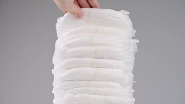 Pile of baby diaper panties diaper isolated on background, close-up, copy space, infant