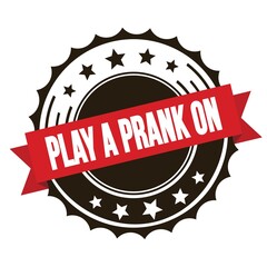 Obraz premium PLAY A PRANK ON text on red brown ribbon stamp.