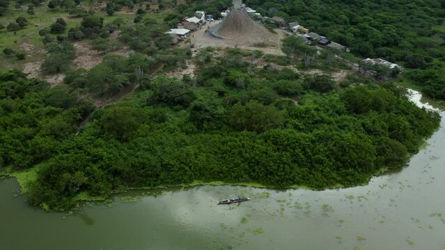 Aerial view of men paddling in the Totumo Swamp in Cartagena, Colombia