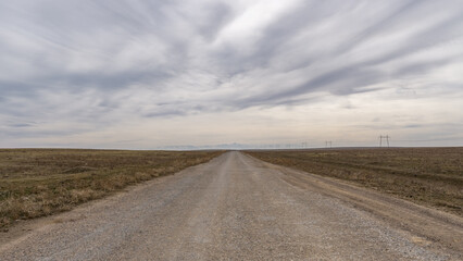 Fototapeta na wymiar The road through the cloudy steppe