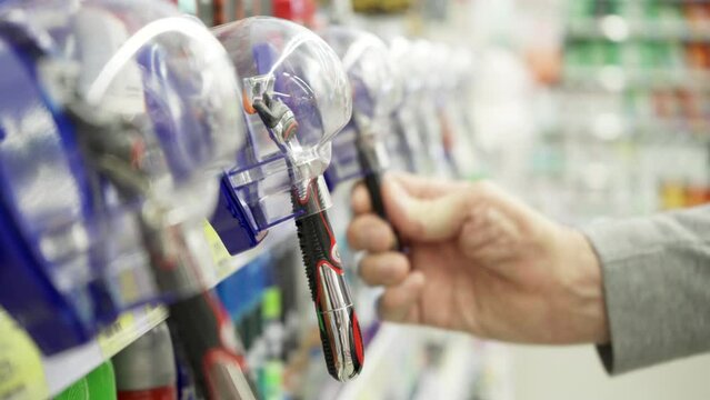 Buyer chooses a razor in the store