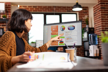 Entrepreneur analyzing management graph working at company strategy in startup office planning financial presentation. Executive manager looking at computer screen with data charts. Business concept