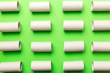 Empty toilet paper roll on colored background. Recyclable paper tube with metal plug end made of kraft paper or cardboard