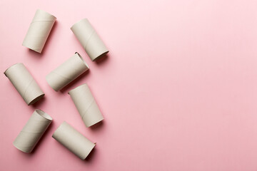 Flat lay composition with empty toilet paper rolls and space for text on color background. Recyclable paper tube with metal plug end made of kraft paper or cardboard