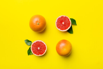 fresh Fruit grapefruit with Juicy grapefruit slices on colored background. Top view. Copy Space. creative summer concept. Half of citrus in minimal flat lay with copy space